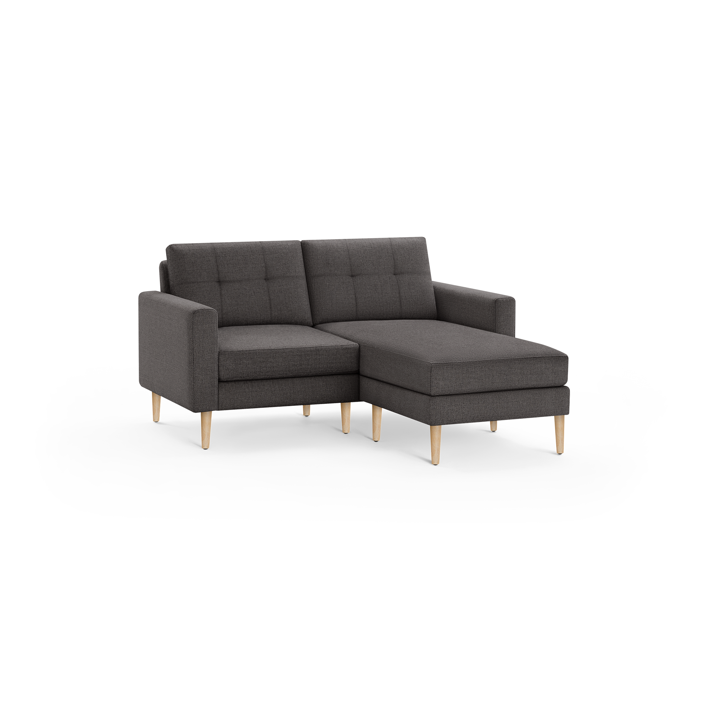 Dark gray fabric sectional sofa with tufted back cushions and light wooden legs, featuring a chaise lounge on the right side.