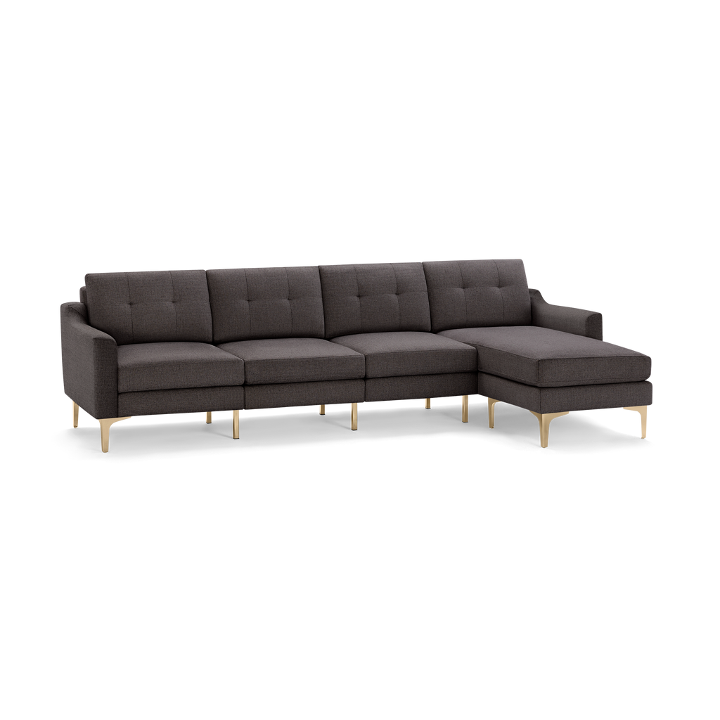 Dark gray fabric sectional sofa with tufted cushions and gold metal legs, featuring a right-side chaise lounge.
