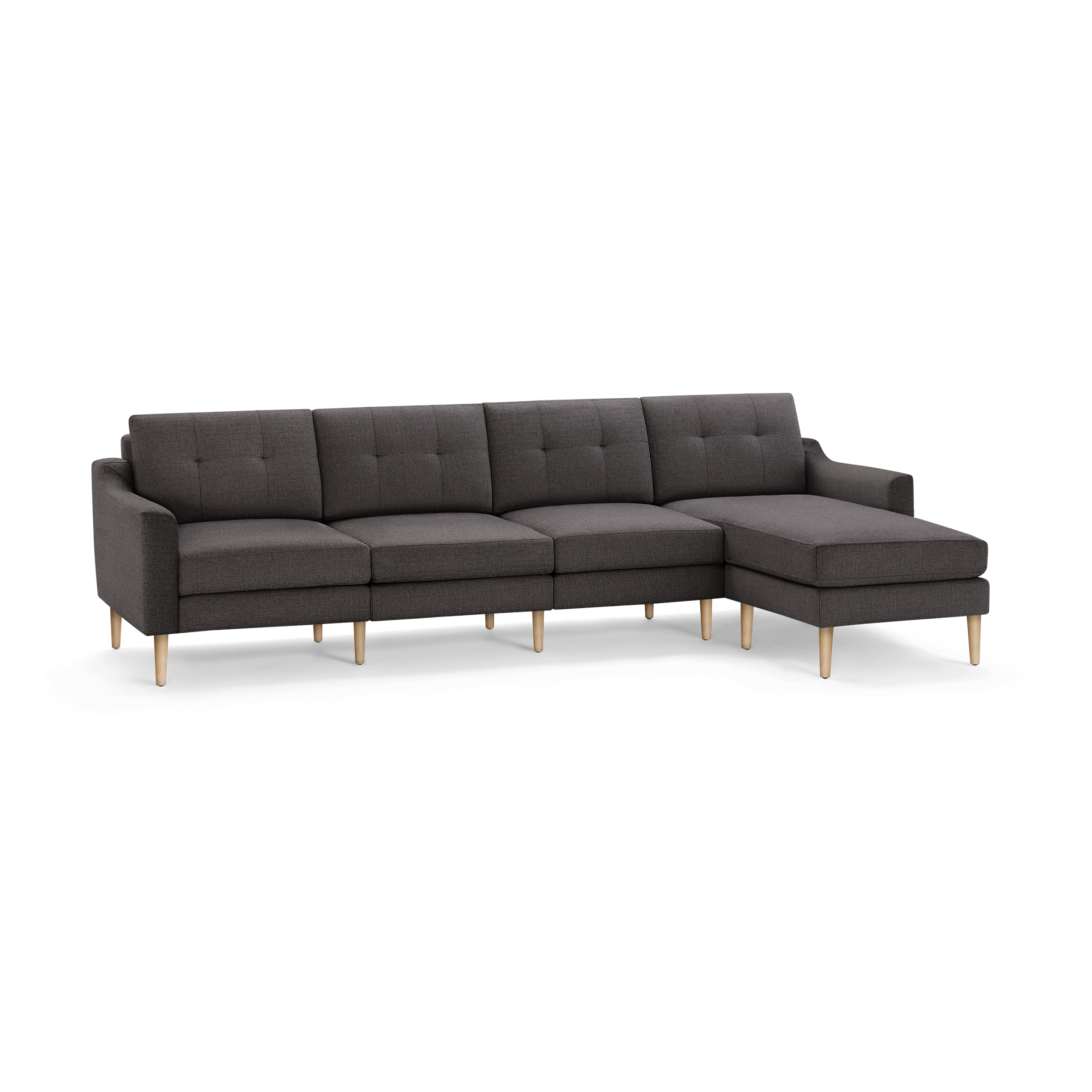 Modern dark gray fabric sectional sofa with tufted cushions and light wooden legs, featuring a chaise lounge on the right side.