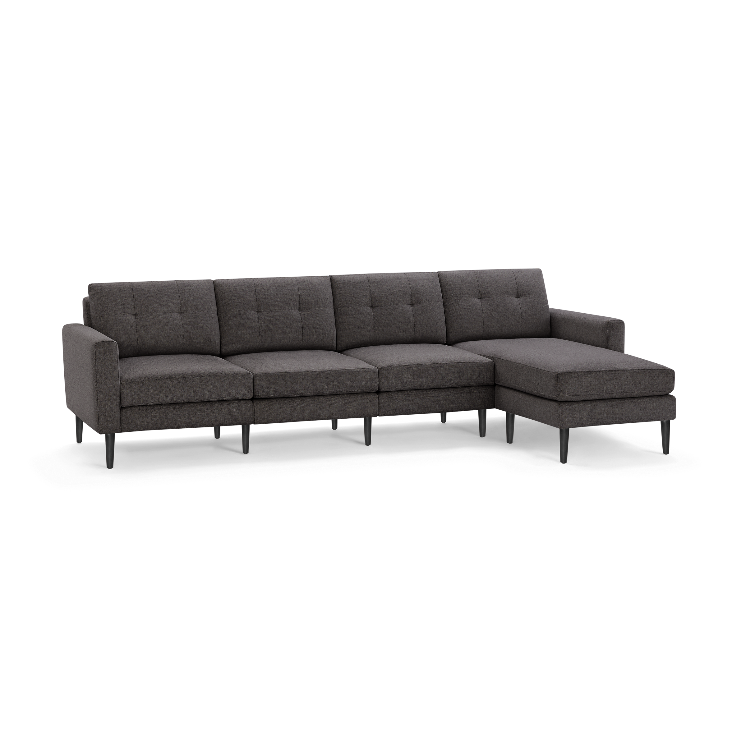 Dark gray fabric sectional sofa with tufted back cushions, straight armrests, and black tapered legs, featuring a chaise lounge on the right side.