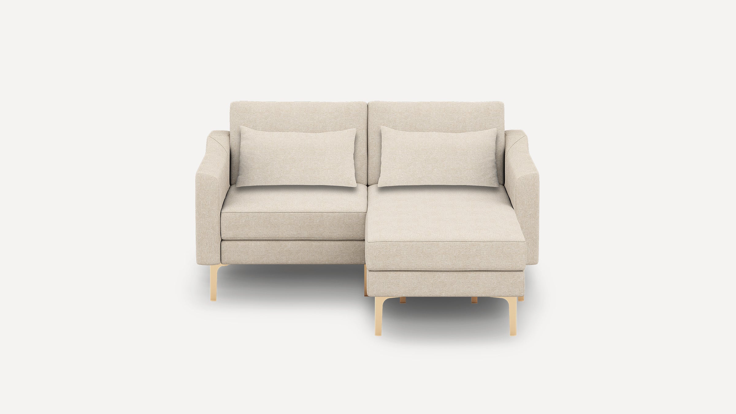 Beige modern sectional sofa with chaise lounge on right side, featuring slim armrests, matching cushions, and sleek light wood legs.