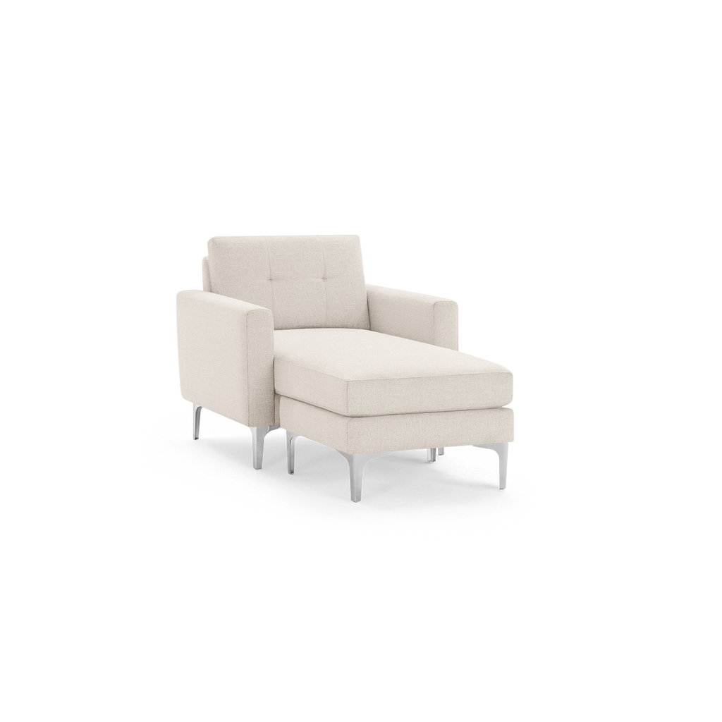Modern beige chaise lounge with tufted backrest, cushioned seat, armrests, and sleek metal legs, designed for comfort and style.