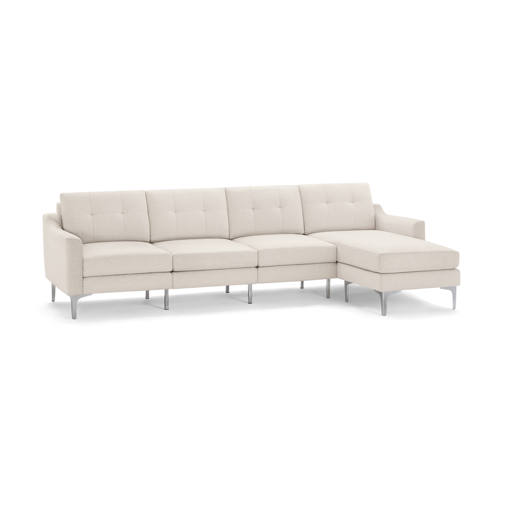 Beige fabric sectional sofa with tufted cushions, slim armrests, and sleek metal legs, featuring a right-side chaise lounge.