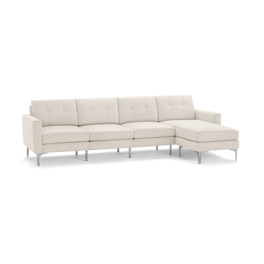 Modern beige fabric sectional sofa with tufted back cushions, right chaise lounge, and sleek metal legs.