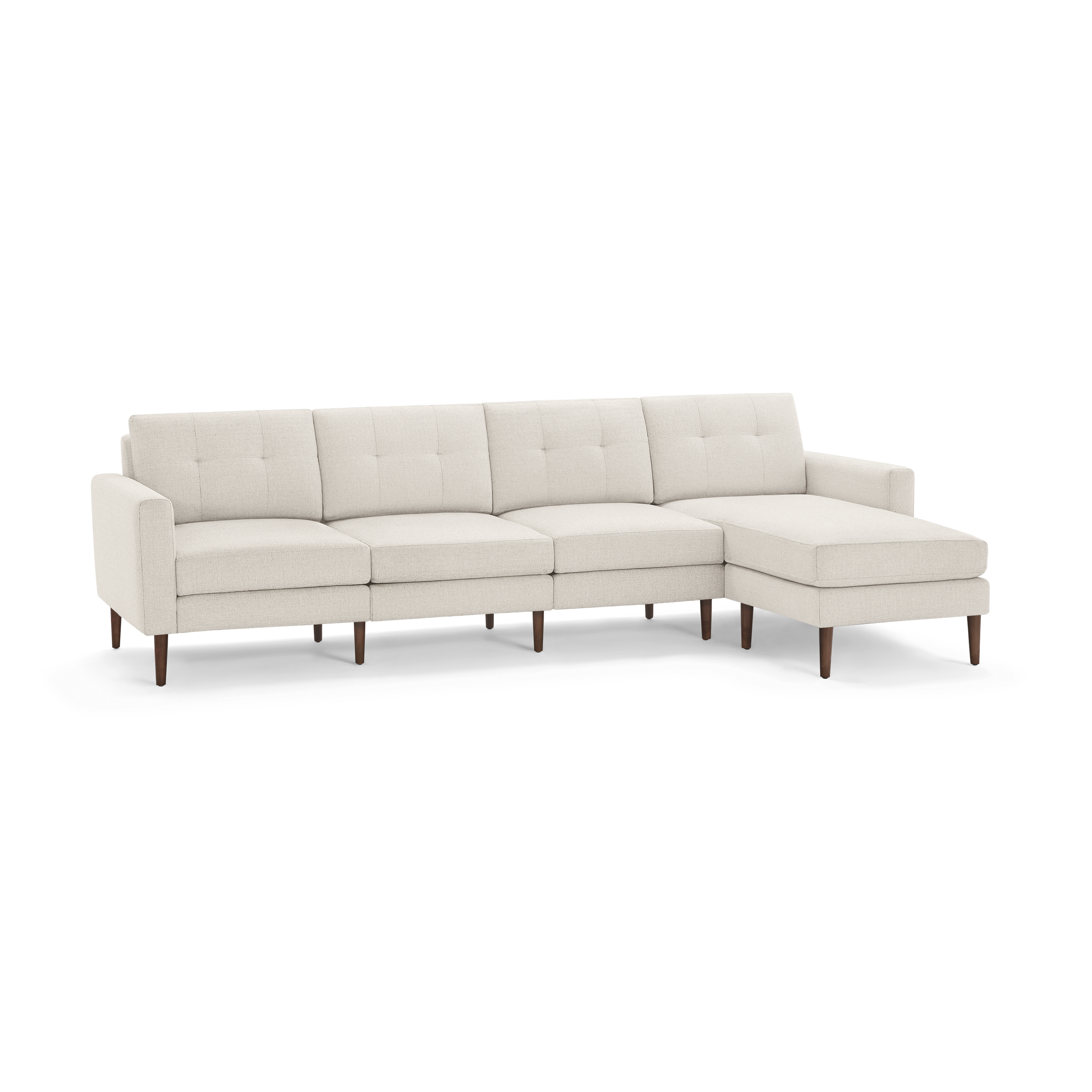 Beige modern sectional sofa with tufted cushions, wooden legs, and chaise lounge on the right side, providing spacious seating.