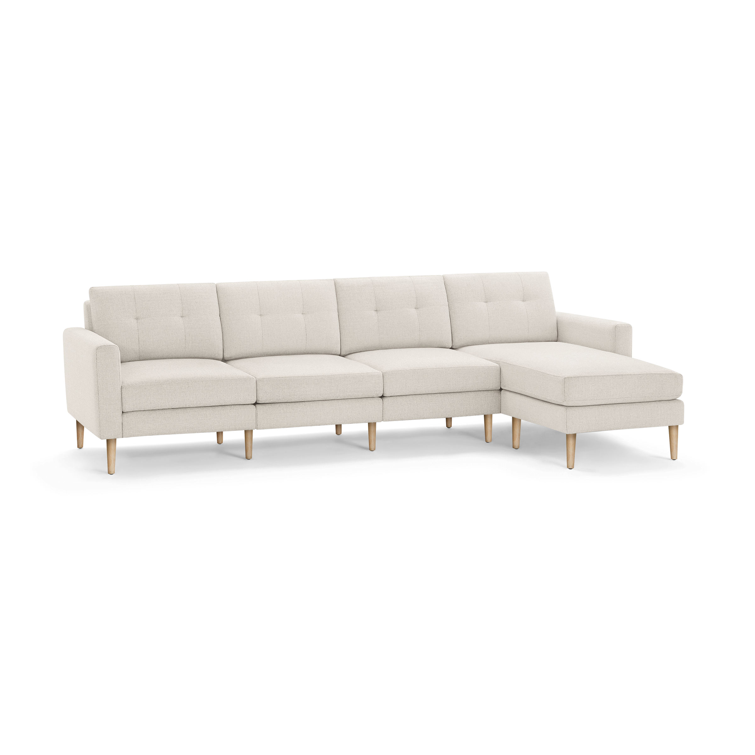 Light beige modern sectional sofa with tufted back cushions, wooden legs, and a right-side chaise lounge.