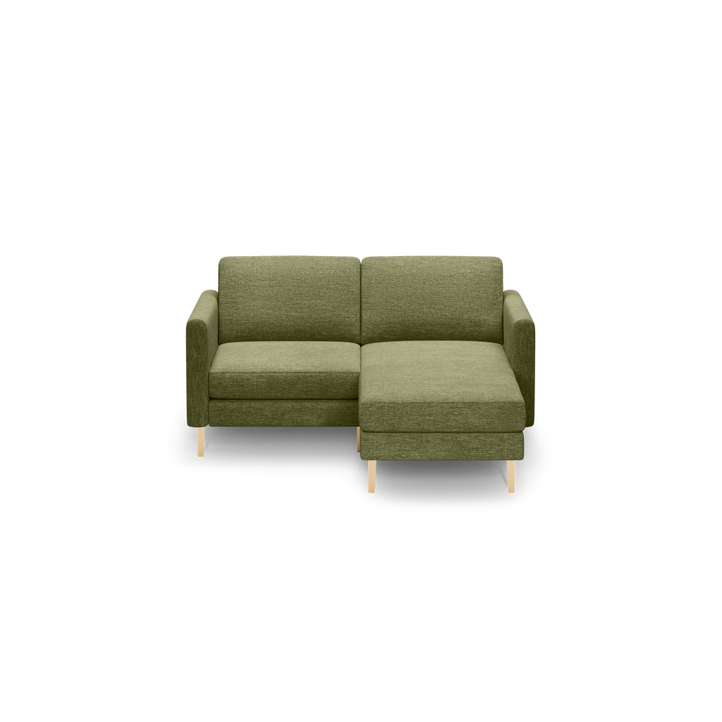 Modern olive green fabric sectional sofa with right-side chaise and light wooden legs on black background.