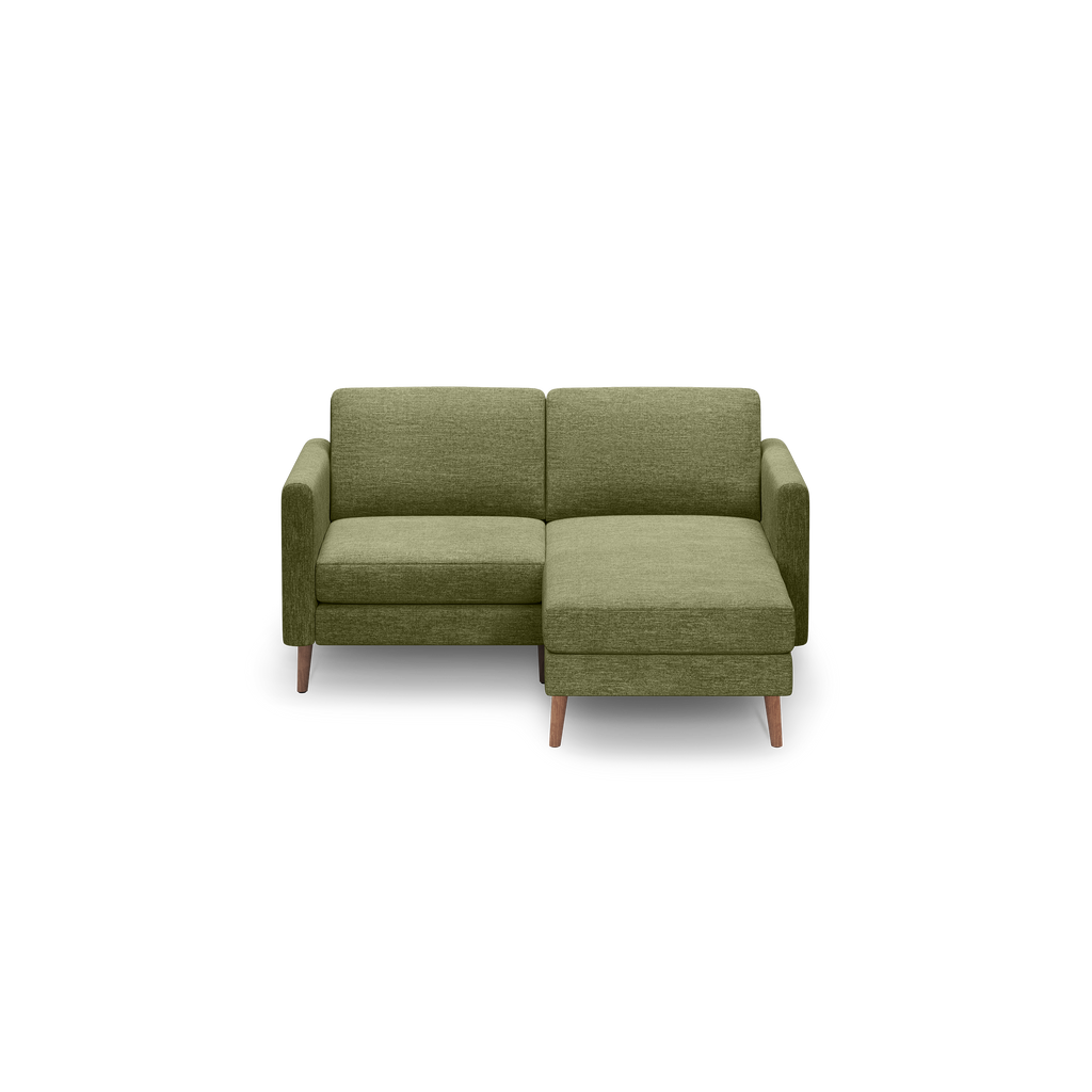 Green fabric upholstered modern sectional sofa with wooden legs and right-side chaise lounge.