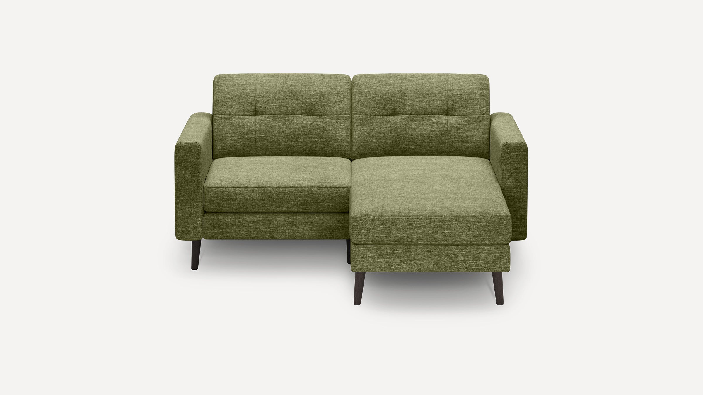 Green fabric sectional sofa with tufted back cushions, square arms, and dark wood tapered legs on white background.