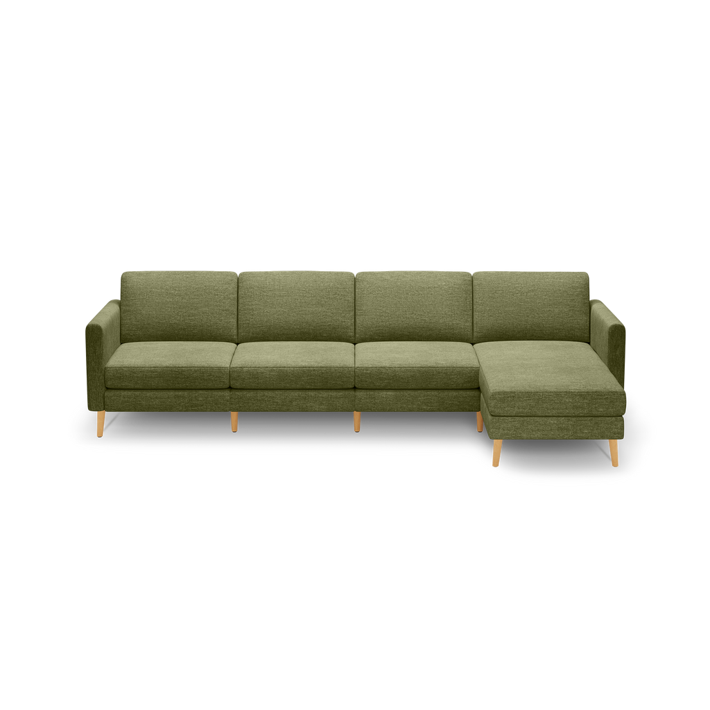 Green fabric sectional sofa with clean lines, wooden tapered legs, includes a chaise lounge on the right side.