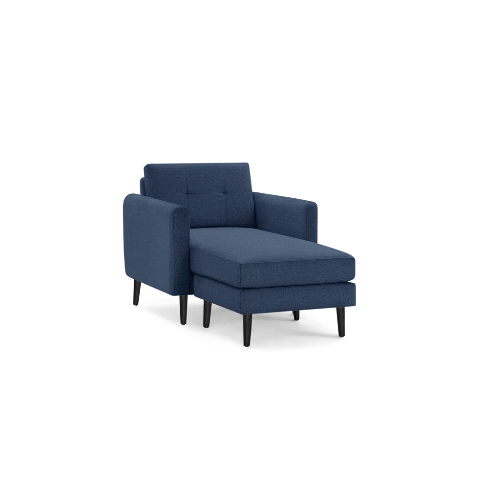 Modern navy blue fabric chaise lounge chair with padded armrests, tufted backrest, and black wooden legs.