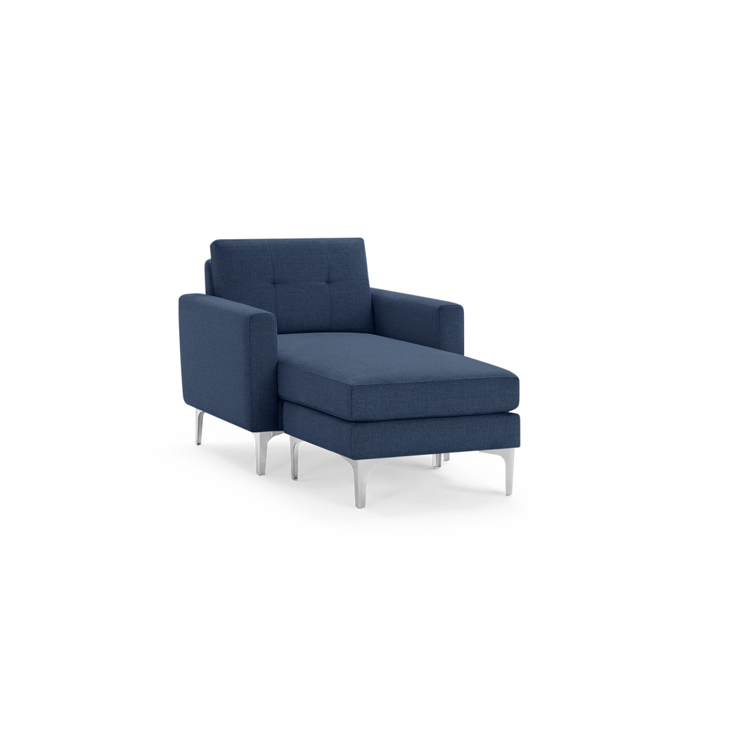 Modern navy blue upholstered chaise lounge chair with tufted backrest, square arms, and sleek chrome legs.