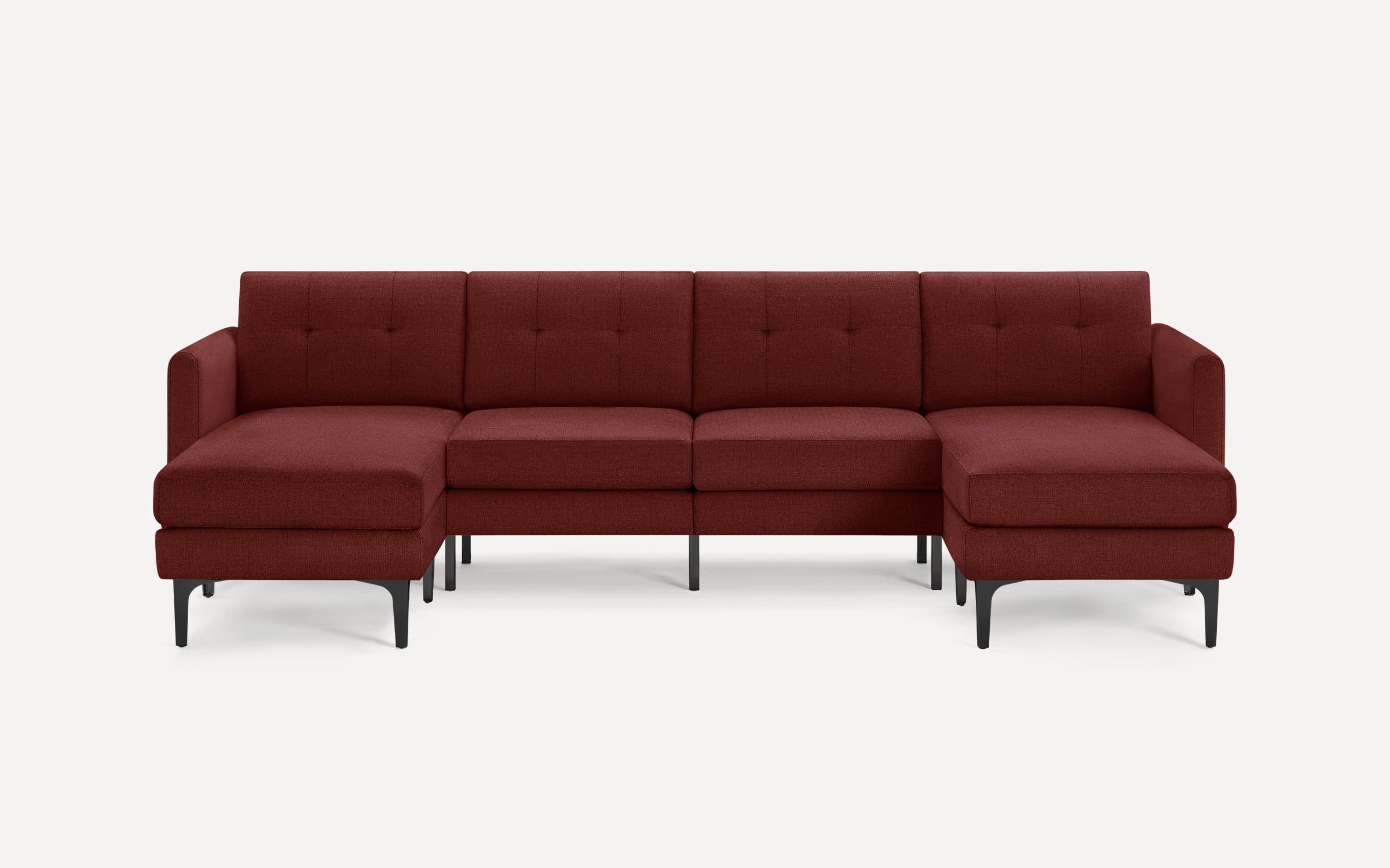 Modern L-shaped sectional sofa in deep burgundy fabric with tufted back cushions and black metal legs, set against a light background.
