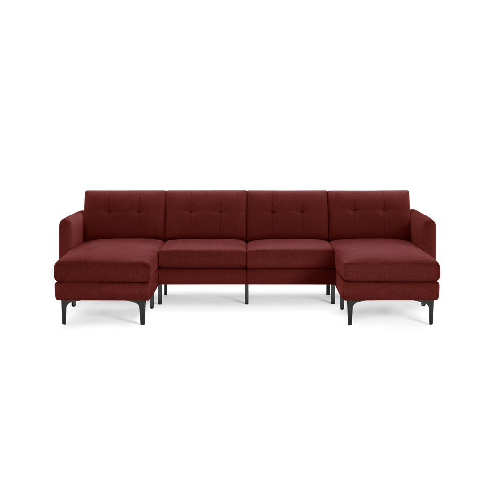 Modern L-shaped sectional sofa in deep burgundy fabric with button-tufted back cushions and black tapered legs.