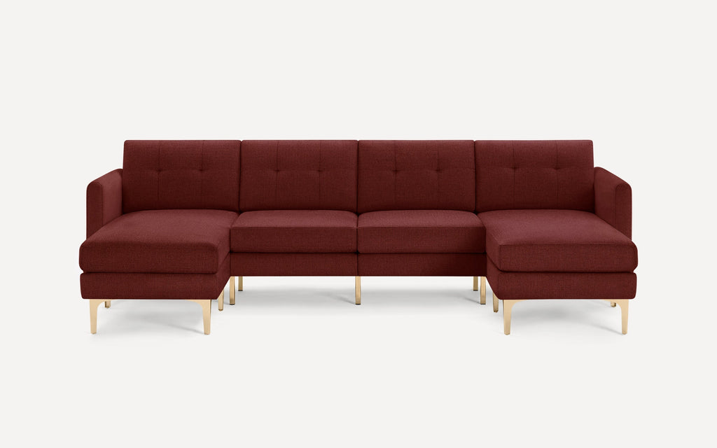 Modern sectional sofa in deep burgundy fabric with tufted back cushions and gold metal legs, featuring left and right chaise ends.