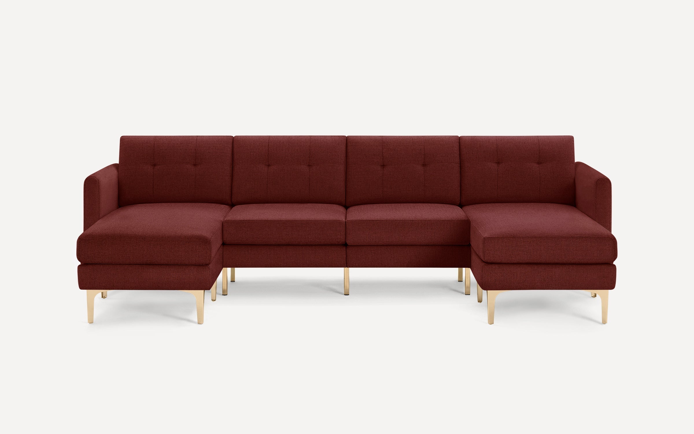 Modern sectional sofa in deep burgundy fabric with tufted back cushions and gold metal legs, featuring left and right chaise ends.