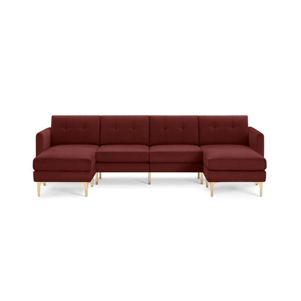 Modern sectional sofa with rich burgundy upholstery, tufted back cushions, and light wooden legs, featuring left and right chaise lounges.