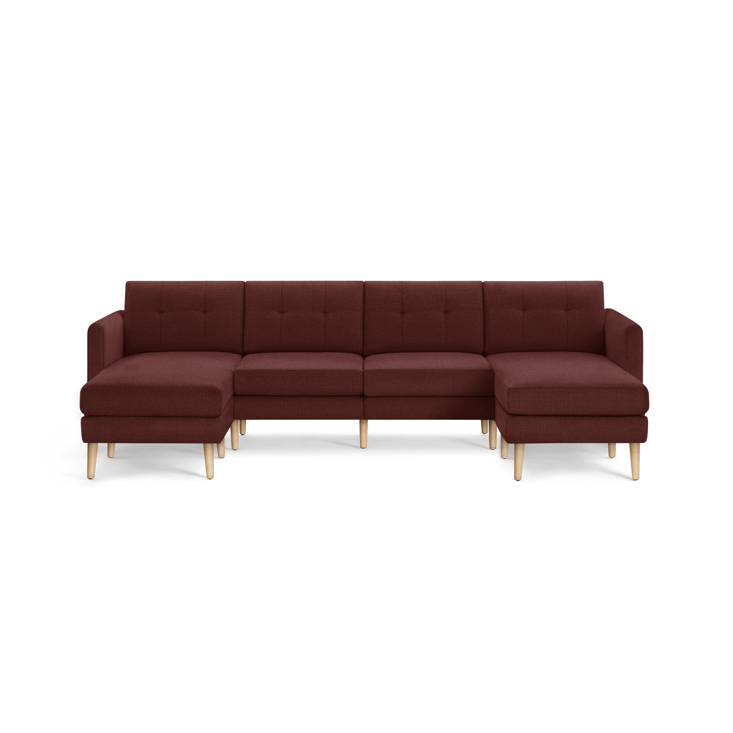 Modern U-shaped sectional sofa in dark red fabric with tufted back cushions and light wooden legs.