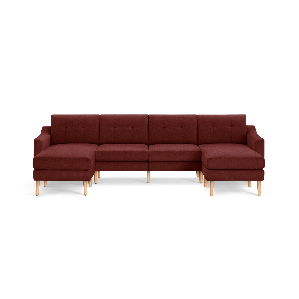 Large L-shaped sectional sofa with dark red fabric upholstery, tufted back cushions, and light wooden legs, designed for spacious seating.
