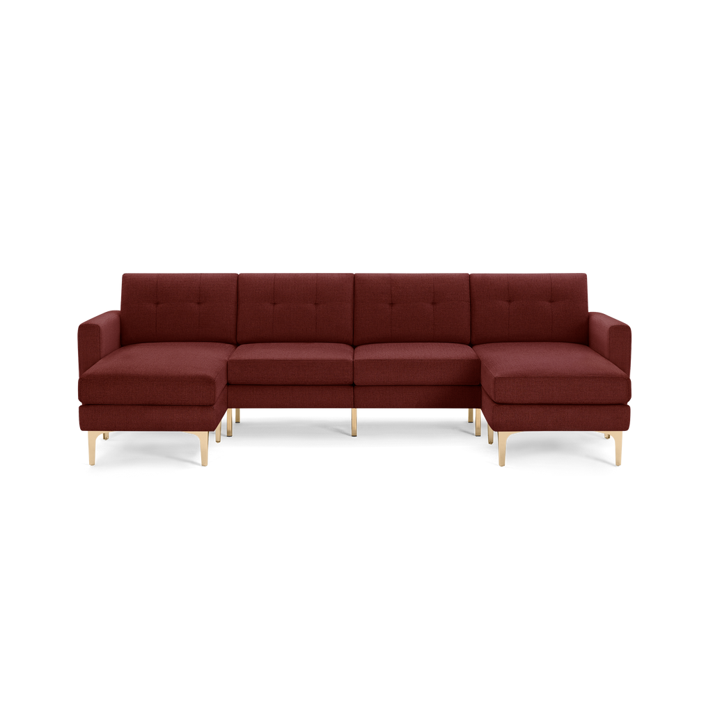 Modern L-shaped sectional sofa in deep rust fabric with tufted back cushions and gold metal legs, featuring wide armrests.