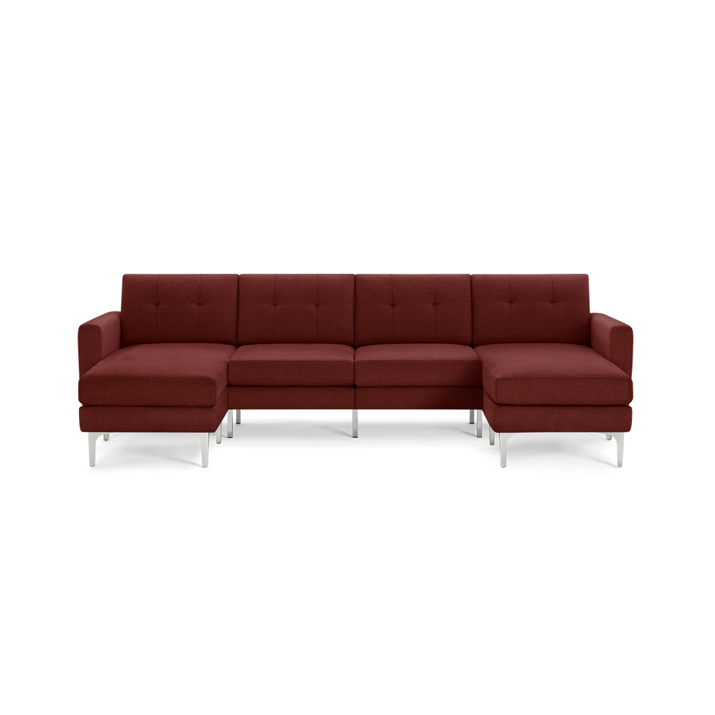 Modern sectional sofa in deep red fabric with tufted cushions, metal legs, and chaise lounges on both sides.
