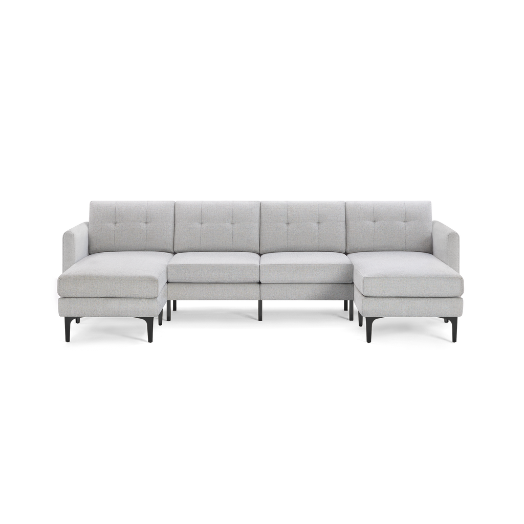 Light gray modern sectional sofa with tufted back cushions, black metal legs, and left and right chaise ends.