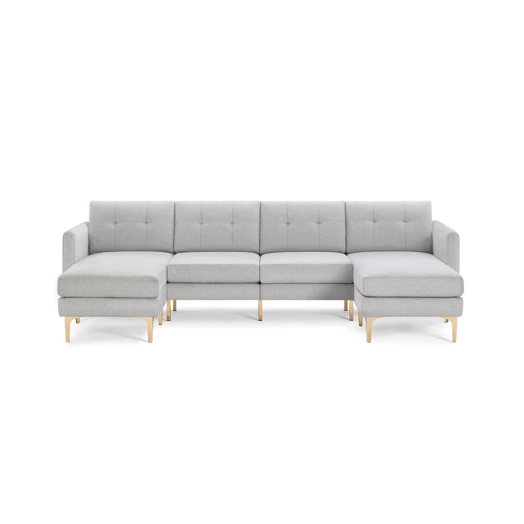 Light gray upholstered sectional sofa with tufted back cushions and gold metal legs, featuring spacious left and right chaise lounges.