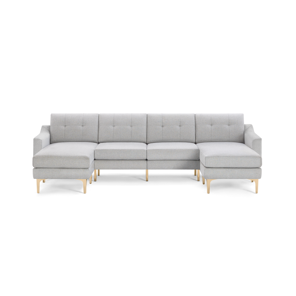 Light gray upholstered sectional sofa with tufted back cushions and gold metal legs, featuring left and right chaise ends.