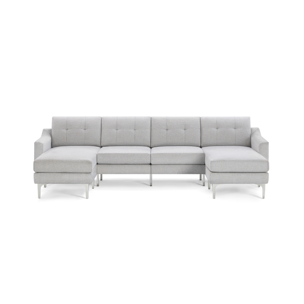 Light gray modern sectional sofa with tufted back cushions, metal legs, and symmetrical chaise lounges on both ends.