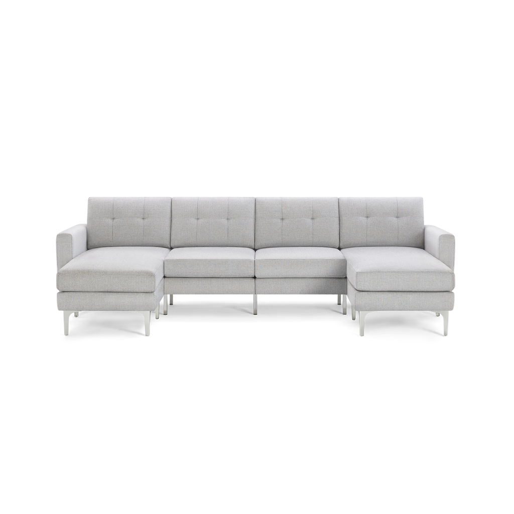 Light gray modern sectional sofa with tufted back cushions, metal legs, and symmetrical chaise lounges on both ends.