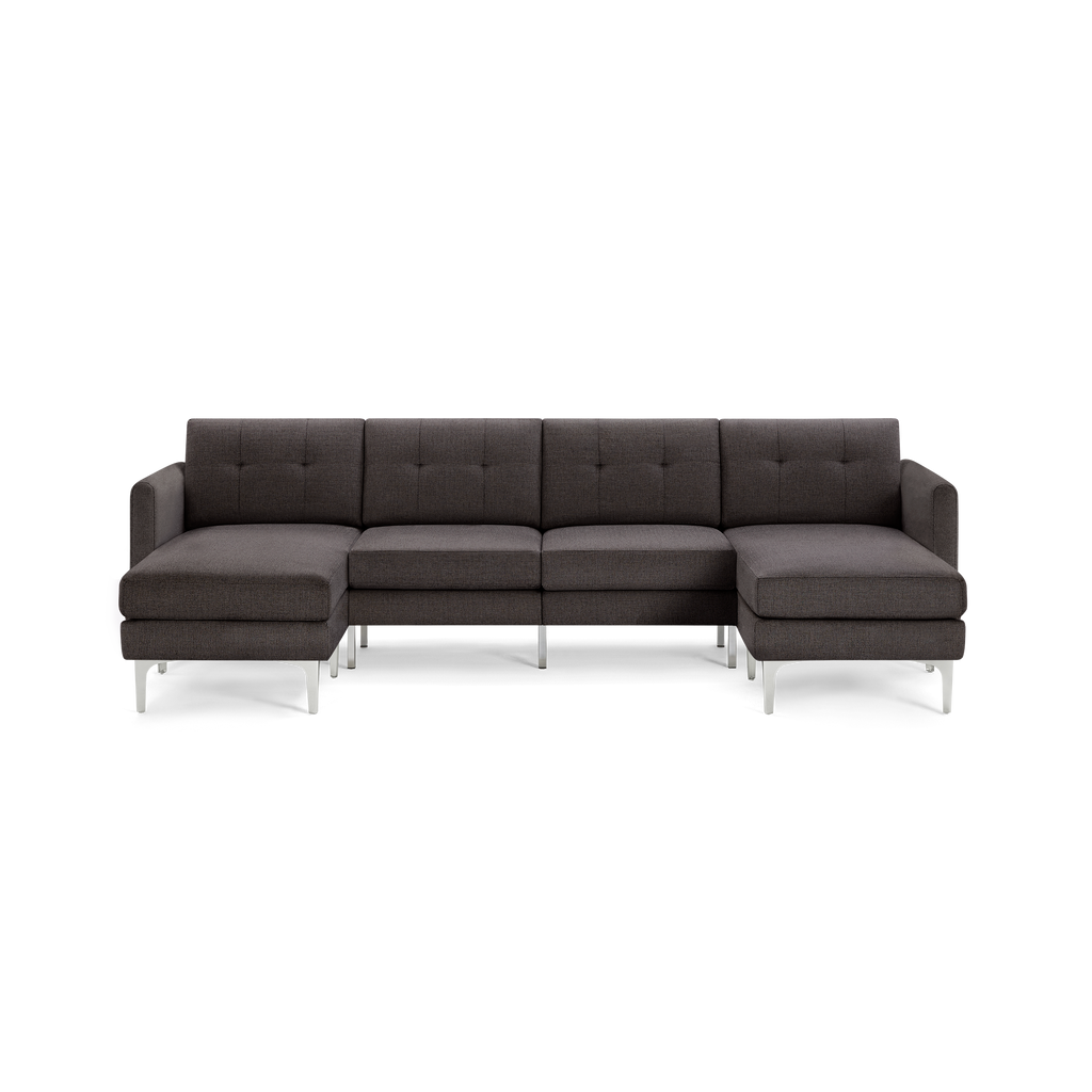 Dark gray fabric sectional sofa with tufted backrest, metal legs, and chaise lounge on both ends, modern design.