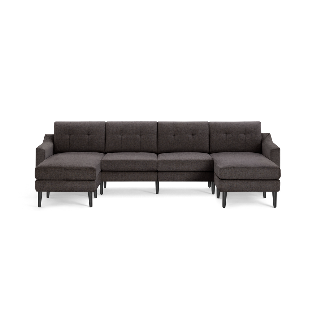 Dark gray fabric sectional sofa with tufted back cushions, L-shaped design, and black tapered wooden legs.