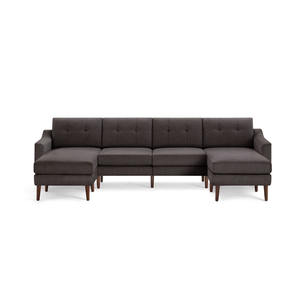 Dark gray fabric sectional sofa with tufted back cushions, wooden tapered legs, and chaise ends on both sides.