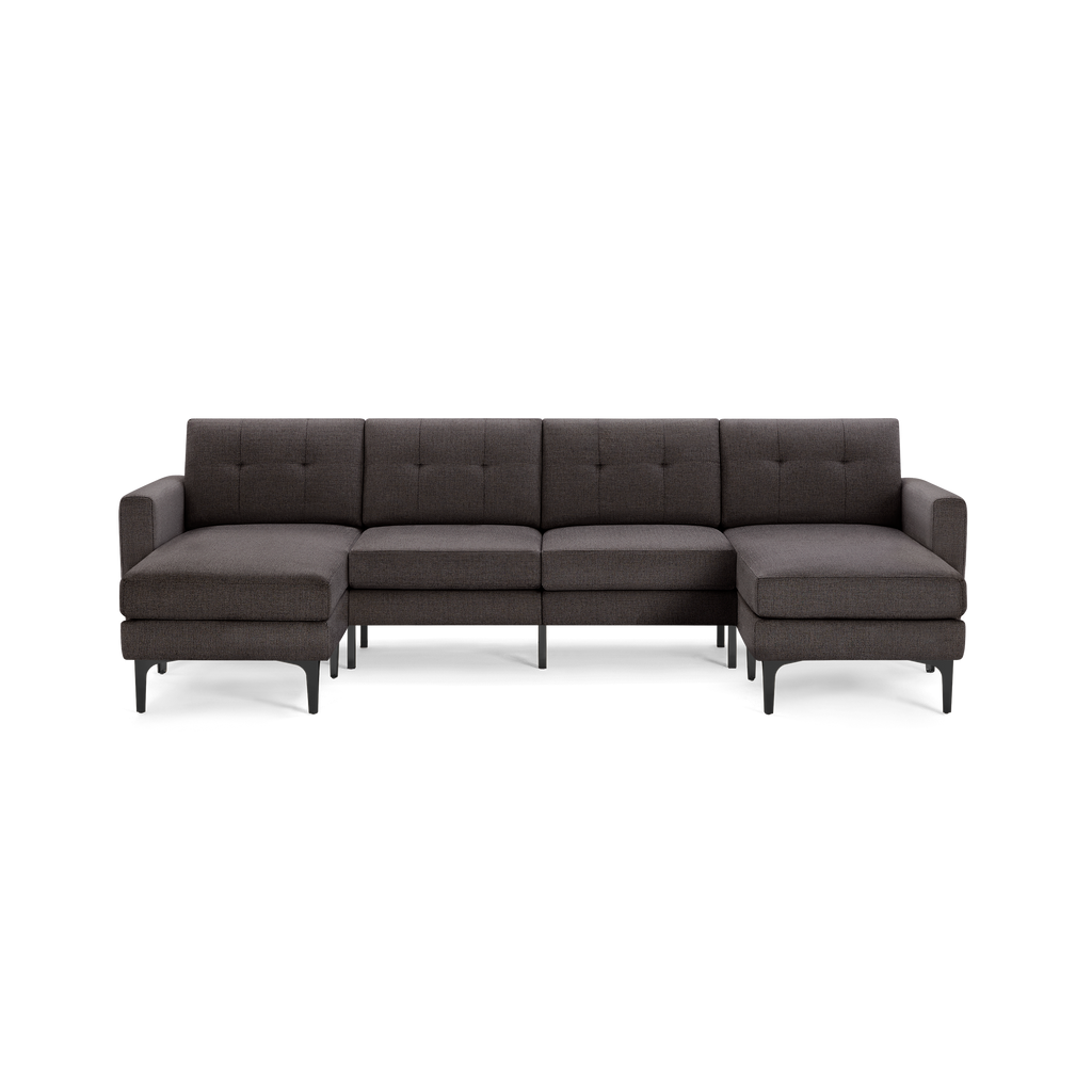 Dark gray upholstered sectional sofa with tufted back cushions, two chaise lounges, and black metal legs.