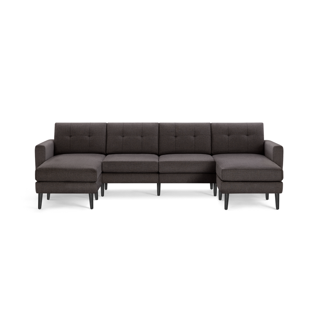 Dark gray upholstered sectional sofa with tufted backrest, left and right chaise lounges, and black tapered wooden legs.