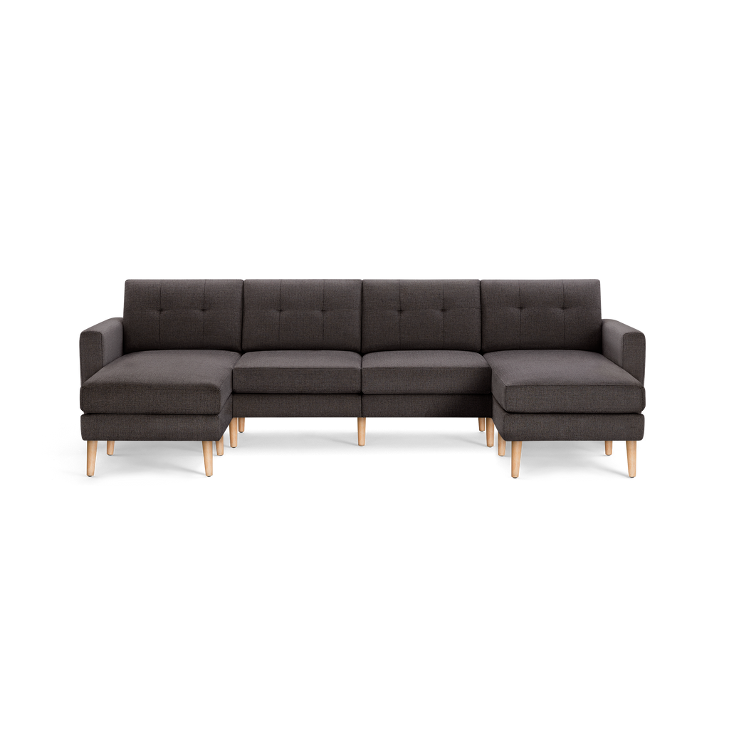 Dark gray L-shaped sectional sofa with tufted back cushions, wooden legs, and armrests on both ends, modern design.