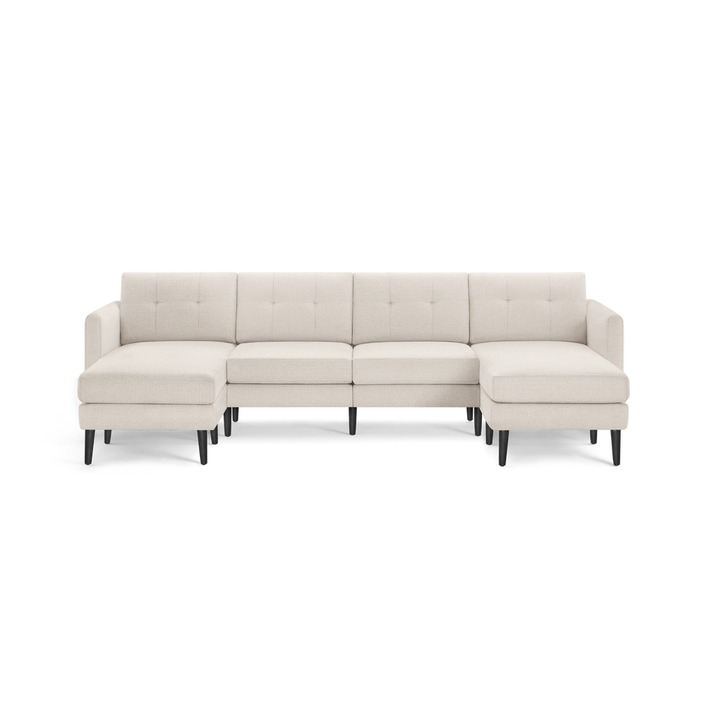 Modern beige fabric sectional sofa with tufted back cushions, L-shaped design, and black wooden legs.