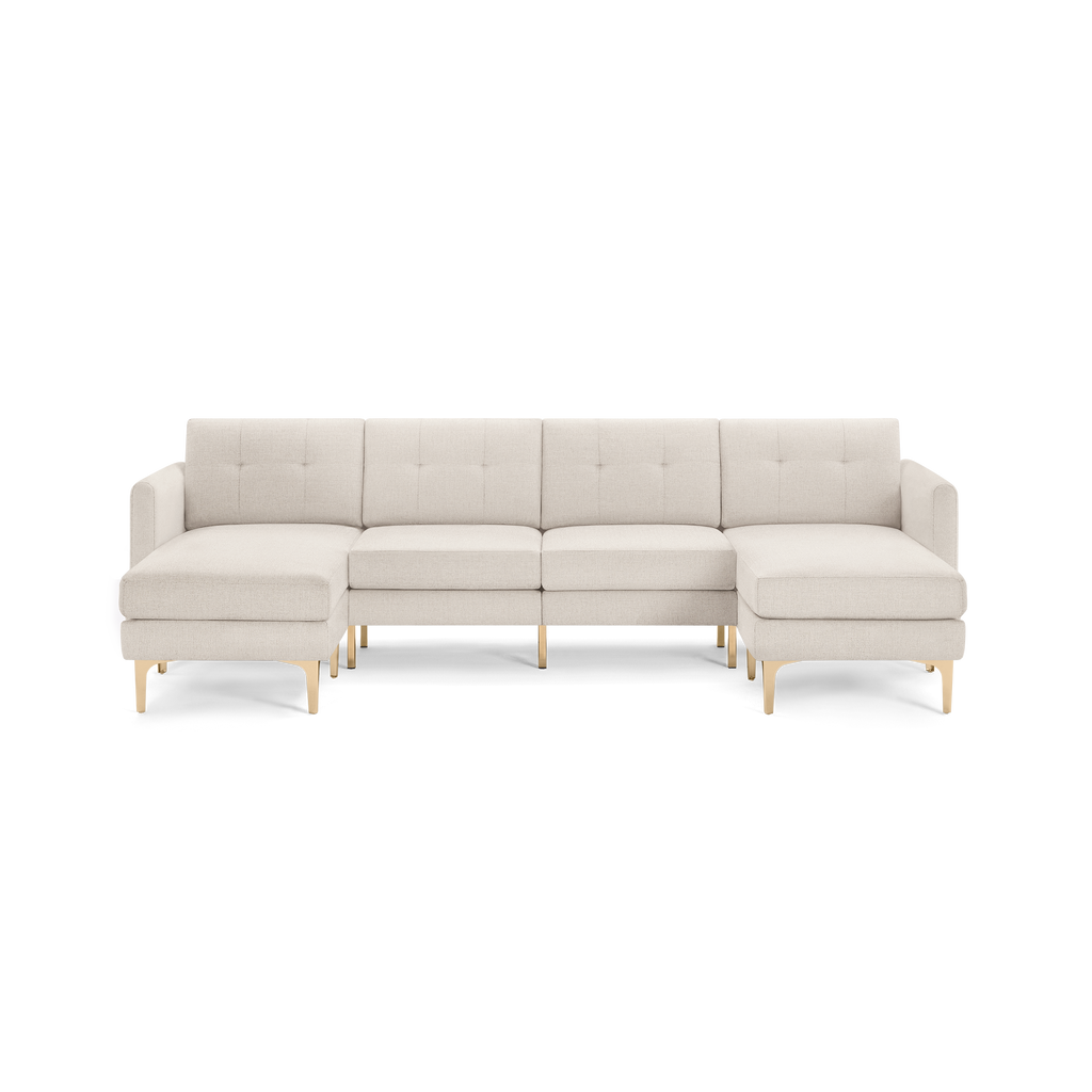 Beige fabric sectional sofa with left and right chaise, tufted back cushions, and light wooden legs, modern design.