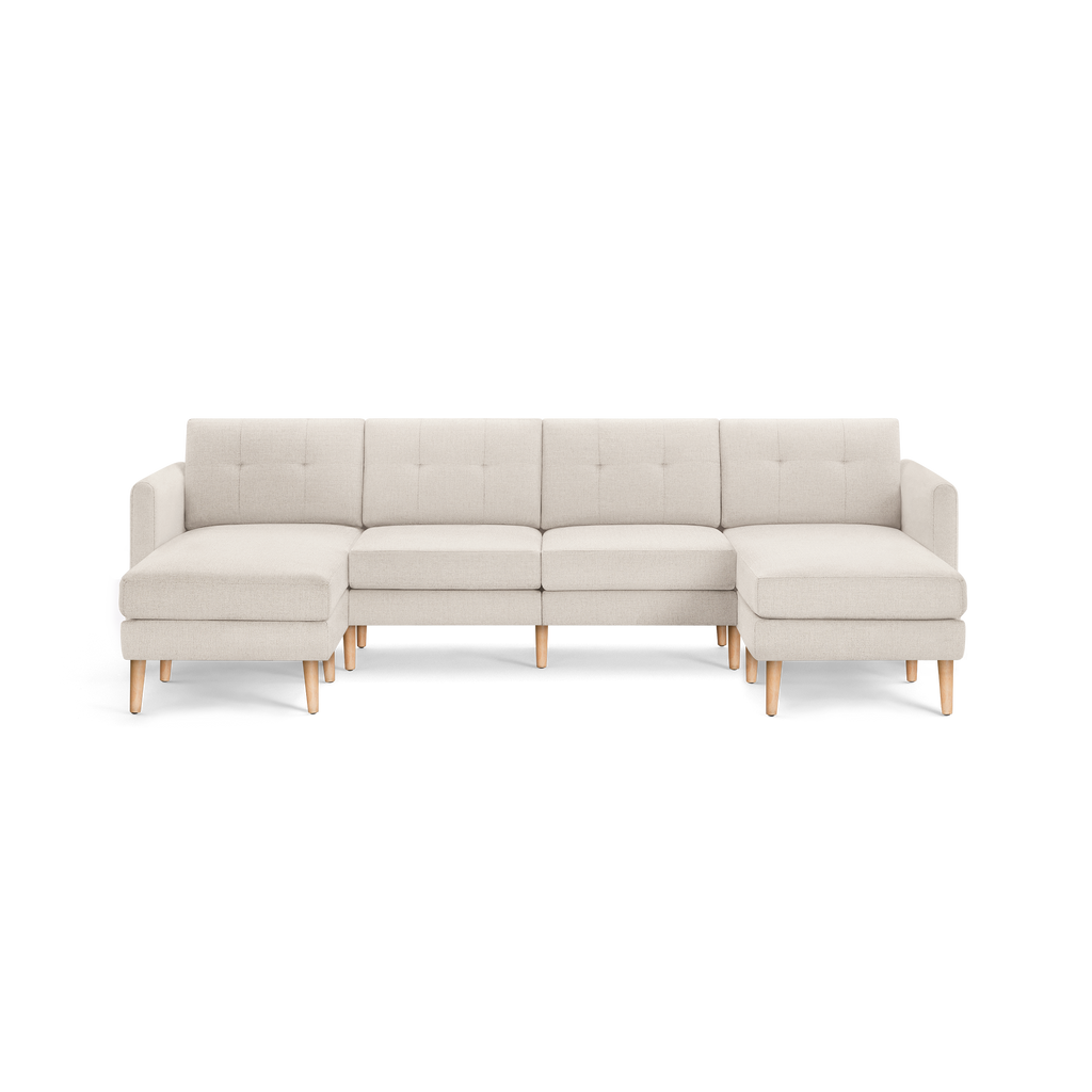 Beige fabric sectional sofa with tufted back cushions and light wooden legs, featuring left and right chaise lounges.