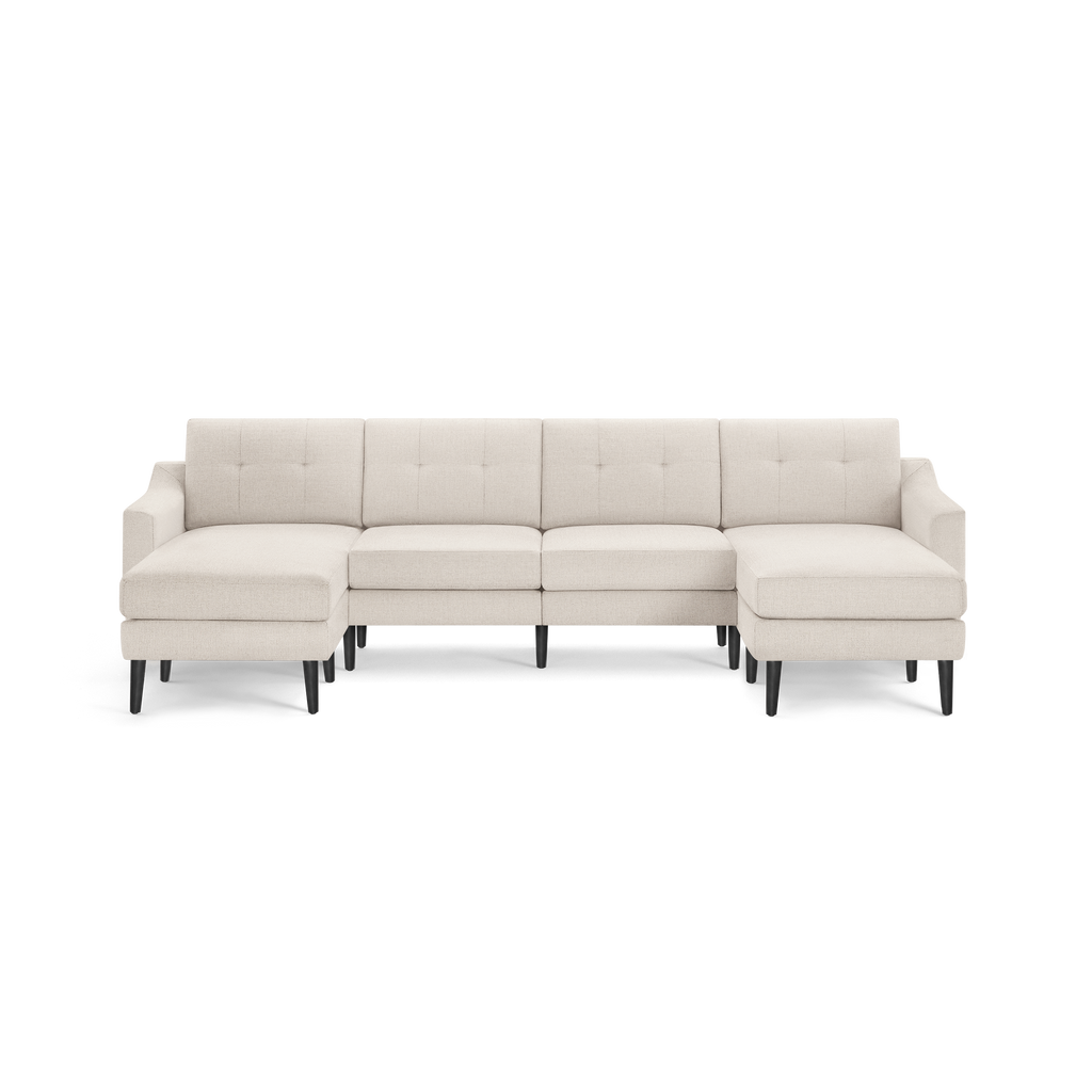 Beige fabric sectional sofa with tufted back cushions, chaise lounge on left and right ends, and black wooden legs.