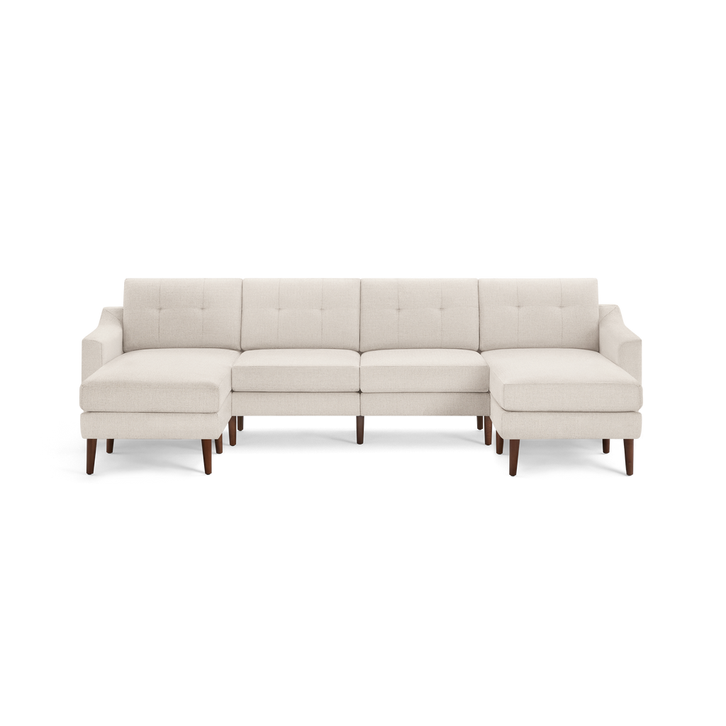 Beige fabric sectional sofa with tufted back cushions, left and right chaise ends, and wooden legs.