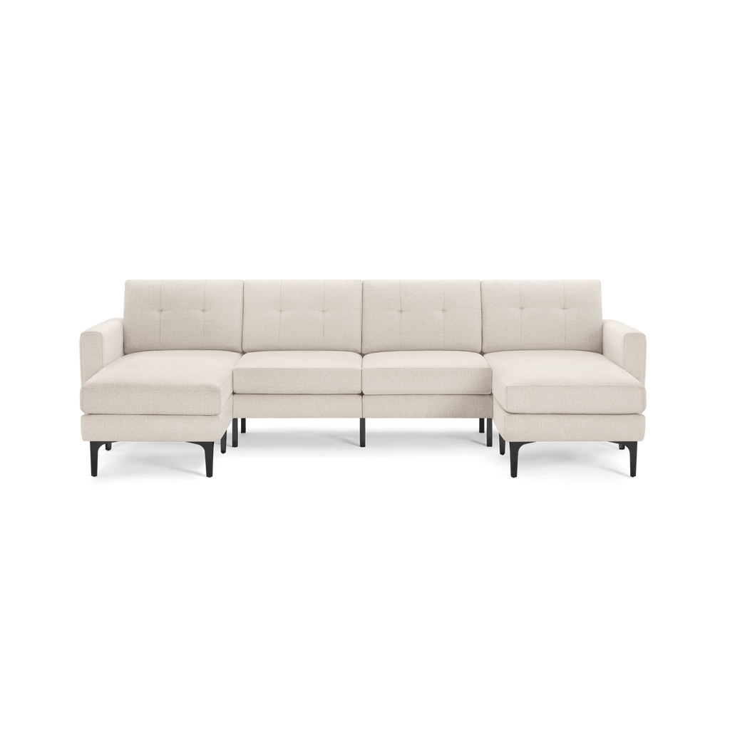 Modern beige sectional sofa with button-tufted back, L-shaped design, and black angled legs, suitable for spacious living rooms.