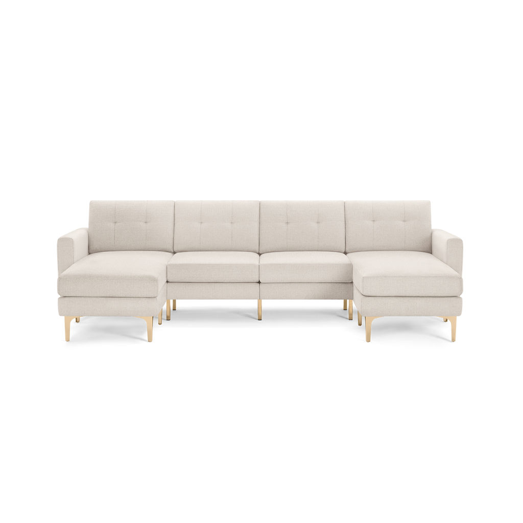 Light beige L-shaped sectional sofa with tufted cushions and wooden angled legs, featuring two chaise lounges on each end.