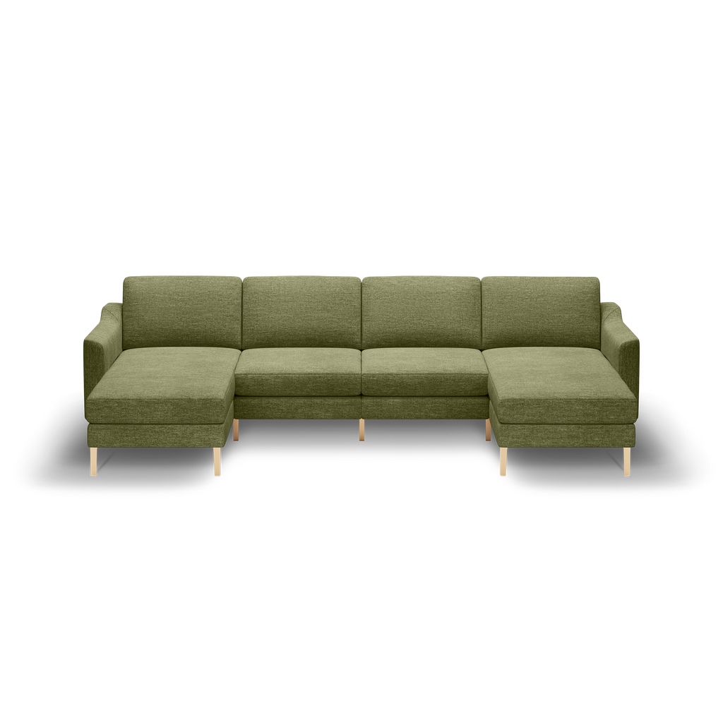 Large olive green sectional sofa with wooden legs, featuring two chaise lounges on each end and firm cushions.