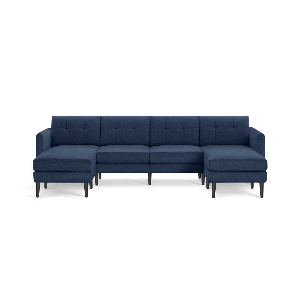 Modern navy blue fabric sectional sofa with chaise lounges on both ends, tufted back cushions, and black wooden legs.