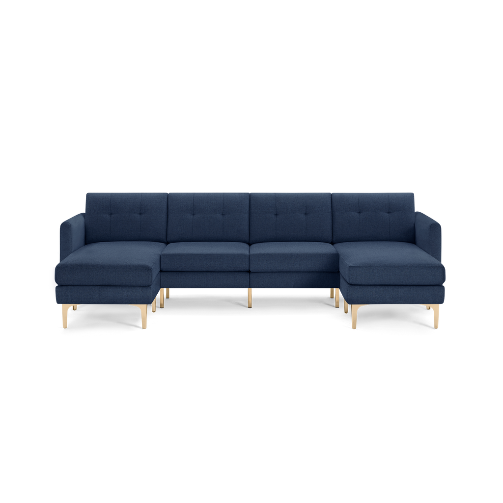 Modern navy blue sectional sofa with tufted cushions, clean lines, and light wooden legs, featuring left and right chaise ends.
