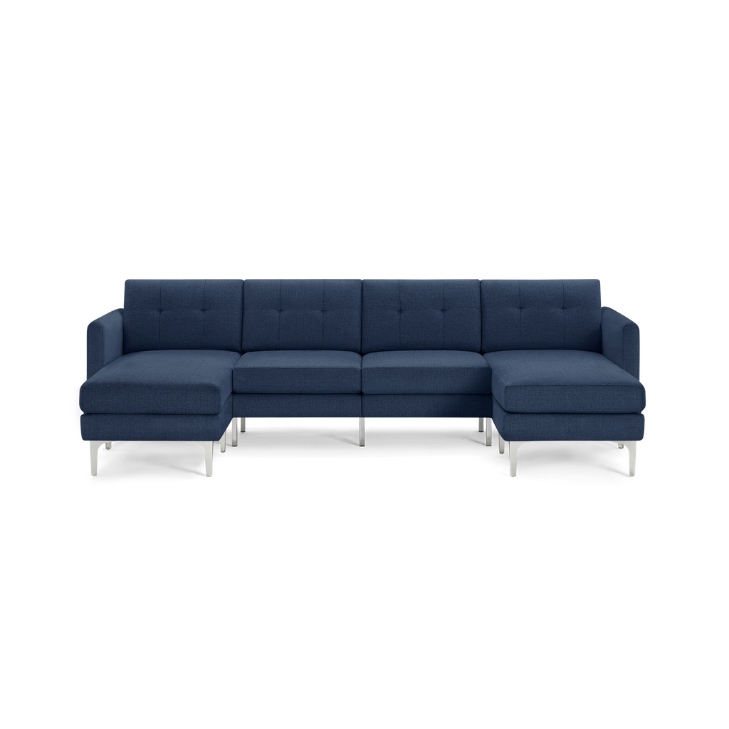 Modern navy blue sectional sofa with chaise lounges on both ends, tufted cushions, and sleek silver metal legs.