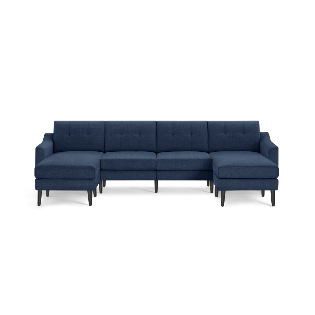 Modern navy blue sectional sofa with tufted back cushions, sleek armrests, and black tapered legs on both sides.