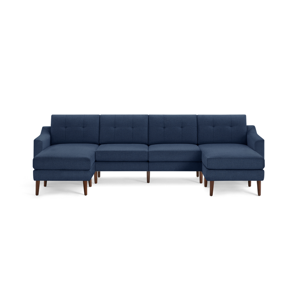 Modern navy blue fabric sectional sofa with tufted back cushions, wooden legs, and symmetrical chaise lounges on each end.