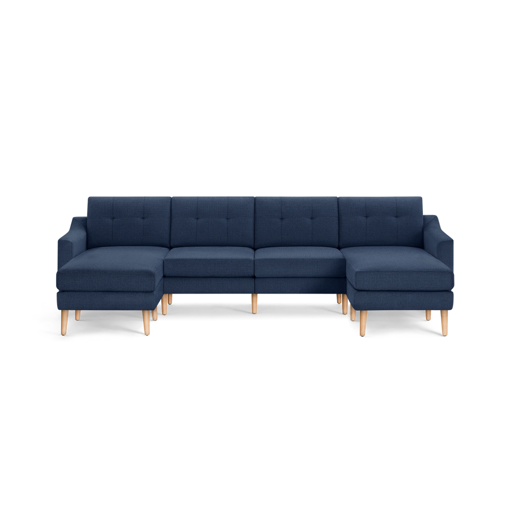 Modern navy blue sectional sofa with tufted back cushions, wooden legs, and L-shaped chaise ends on both sides.